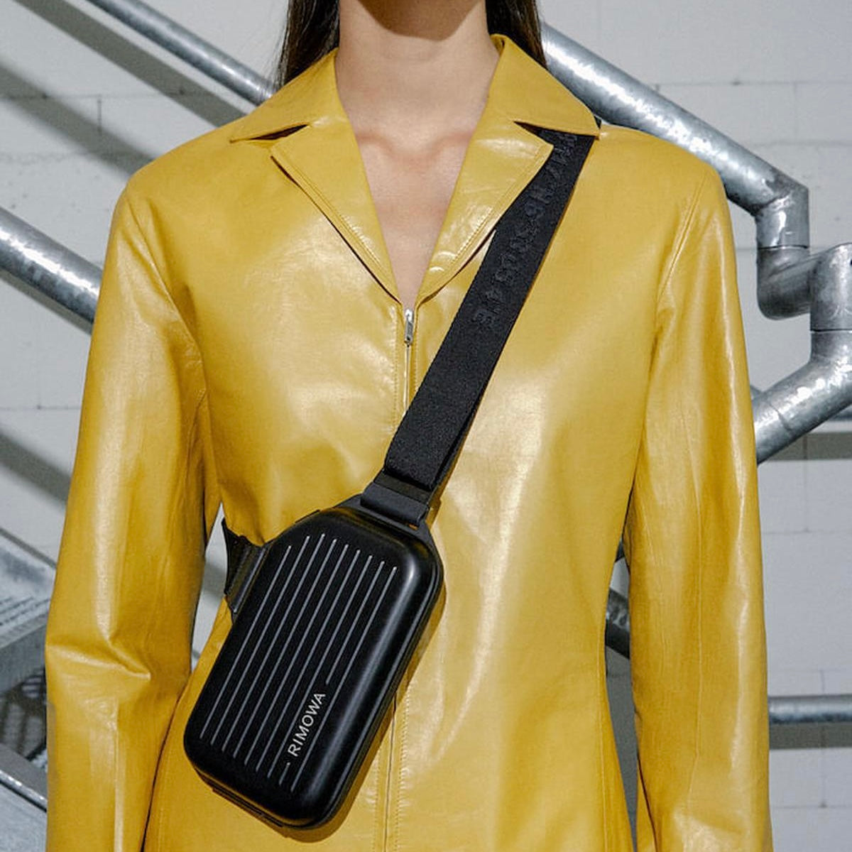 The RIMOWA Aluminum Logo Sling Clutch