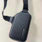 The RIMOWA Aluminum Logo Sling Clutch